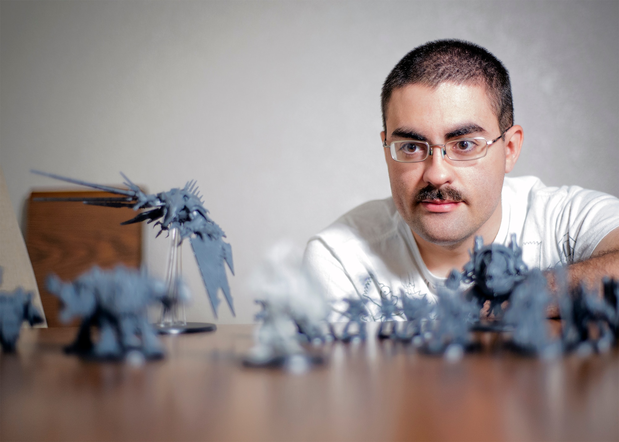 501 Senior Airman Thomas White, a 71st Operations Support Squadron airfield systems maintainer, and his Warhammer 40,000 army at his home in Enid, Oklahoma, June 16. The popular tabletop war game was first released in 1983. (U.S. Air Force photo / David Poe)

