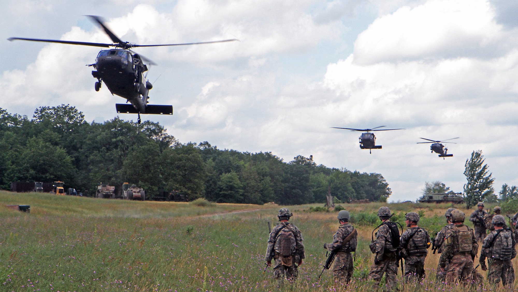 Soldiers assigned to Troop C, 1st Battalion, 126th Cavalry Regiment await extraction on the air-to-ground gunnery range on Camp Grayling Joint Maneuver Training Center after a combined live-fire exercise as part of Northern Strike 15, July 20, 2015. NS 15 is a mass training exercise hosted annually on CGJMTC and evaluates joint air-to-ground capability of participating units from across the country as well as partnering nations. (U.S. Army photo by Sgt. Seth LaCount/Released)