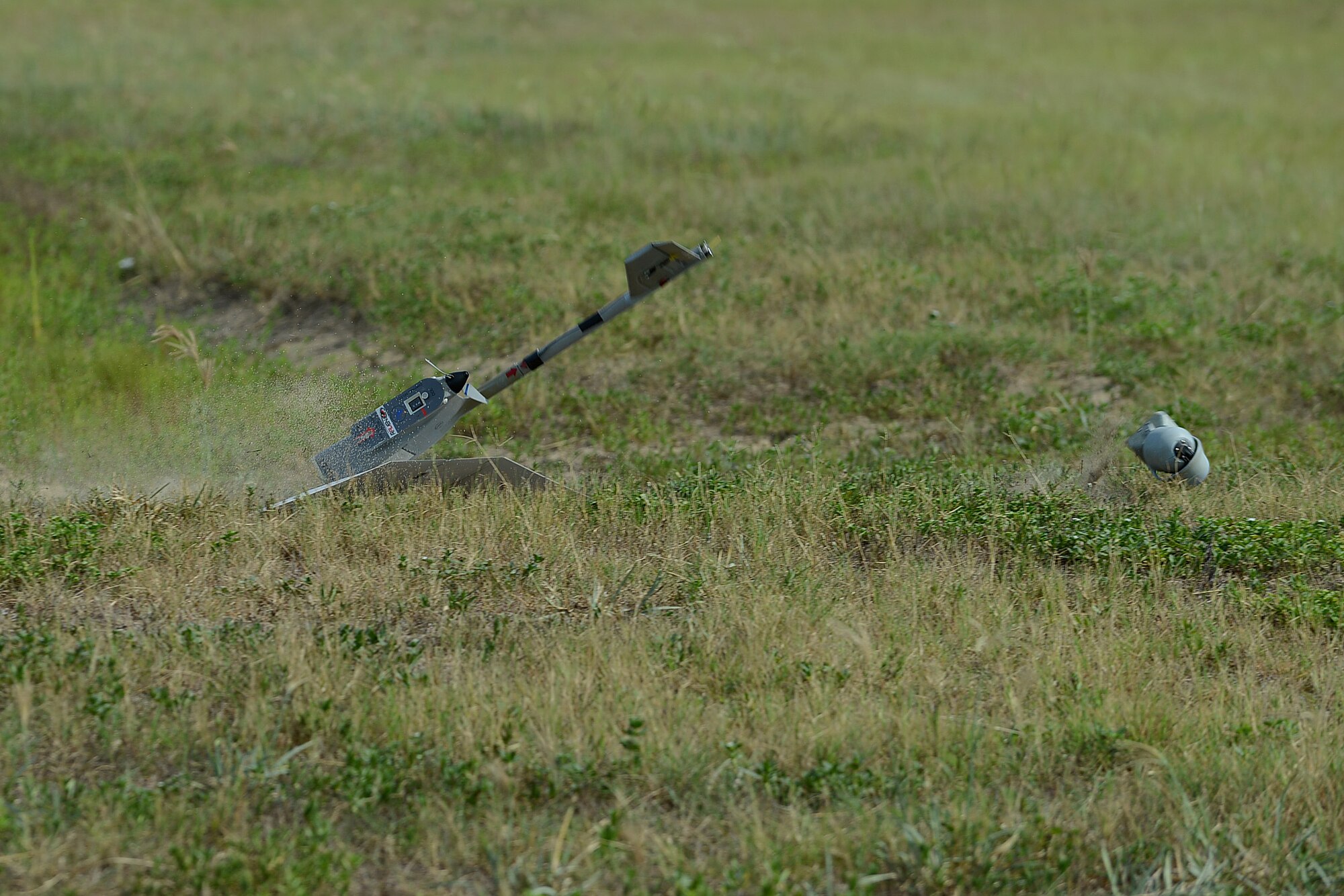 A RQ-11B Raven, a Small Unmanned Aerial System, snaps apart safely while landing during training at Poinsett Electronic Combat Range, Wedgefield, S.C., July 28, 2015. The SUAS is built to break apart in order to absorb the shock of landing without wheels and is easily put back together for continued use. (U.S. Air Force photo by Senior Airman Diana M. Cossaboom/Released)