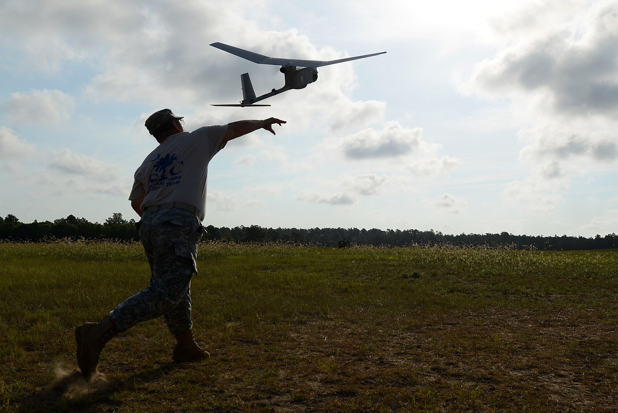 U.S. Army National Guard Sgt. 1st Class Rene Wilson, South Carolina Army National Guard Marksmanship Training Unit soldier, launches a RQ-11B Raven into flight during training on Small Unmanned Aerial Systems at Poinsett Electronic Combat Range, Wedgefield, S.C., July 28, 2015. In 2013, the range provided training for 754 aircraft from three Department of Defense services and three National Guard stations. (U.S. Air Force photo by Senior Airman Diana M. Cossaboom/Released)
