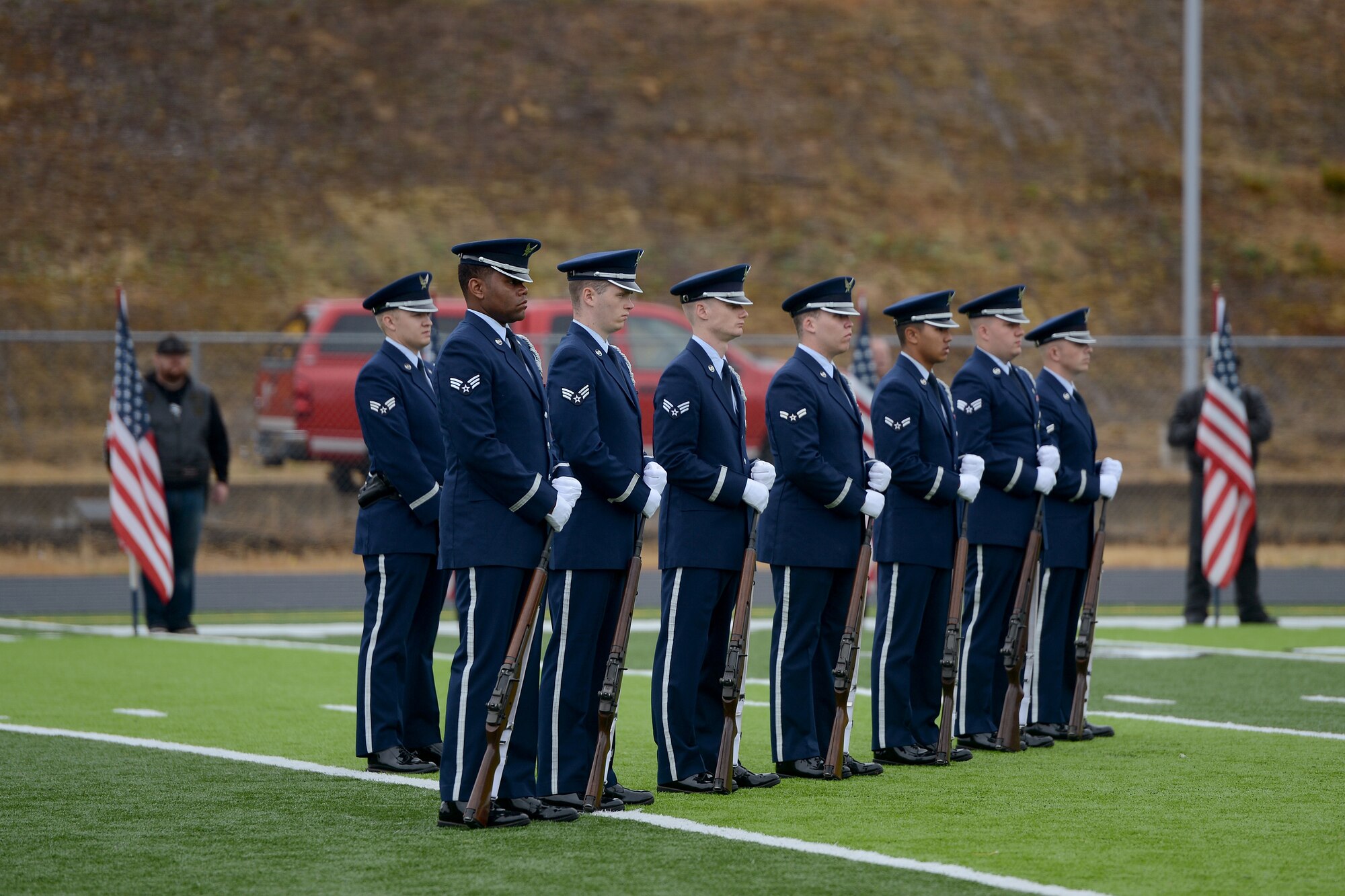 Members from the McChord Field Honor Guard firing party team wait July 25, 2015, during an active duty honors ceremony at Waldport High School, Ore. With an active duty honors ceremony, the honor guard team provides a pallbearer team, a firing party, a color guard team, and a bugler. (U.S. Air Force photo/Airman 1st Class Keoni Chavarria)