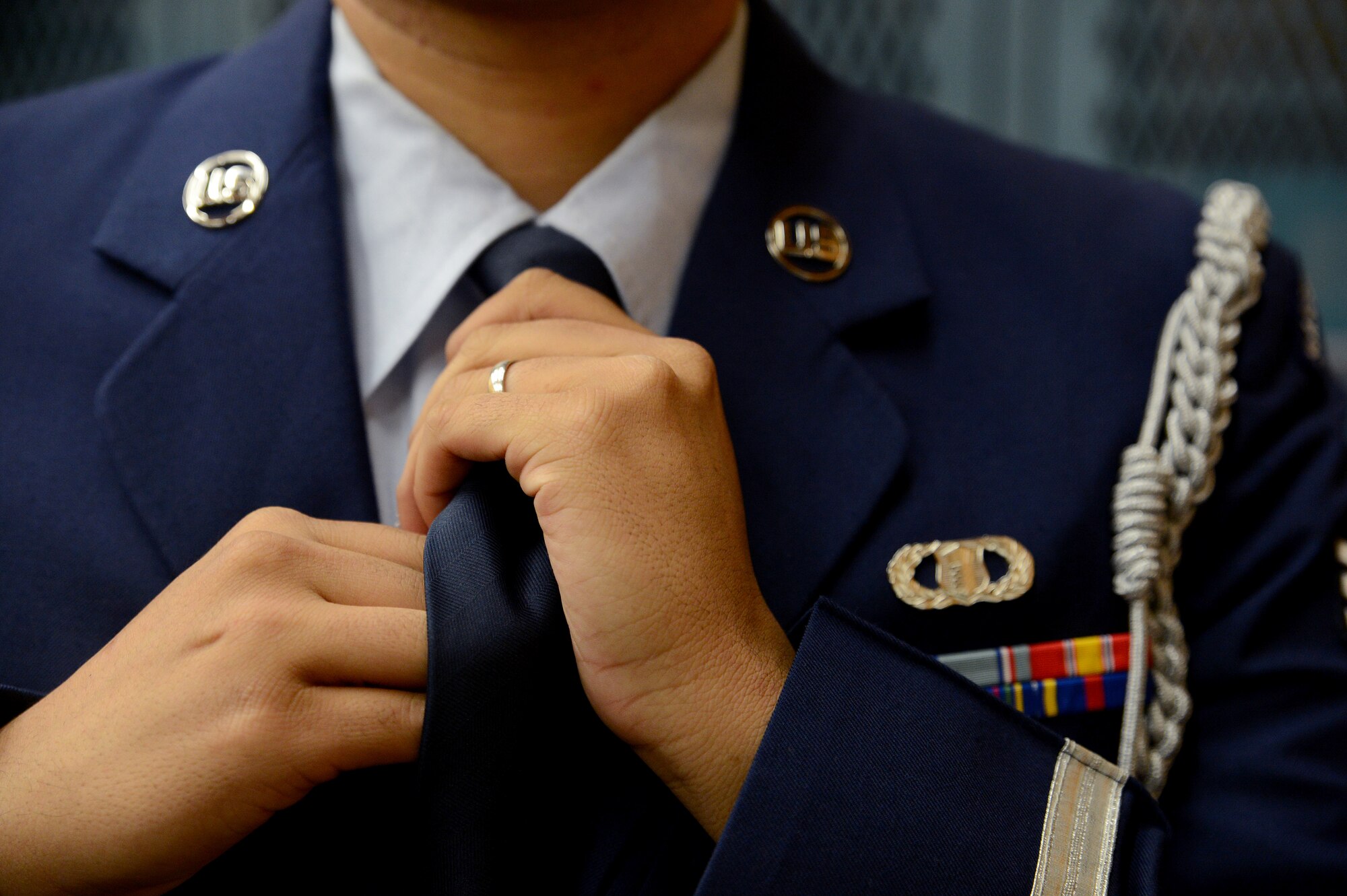 Senior Airman Alex Maldonado, McChord Field Honor Guard pallbearer team member, fixes his tie July 25, 2014, before an active duty honors ceremony at Waldport High School, Ore. The McChord Field Honor Guard team travels to many areas to cover various events and is accustomed to changing in any area available to be prepared for their ceremonies. (U.S. Air Force photo/Airman 1st Class Keoni Chavarria)