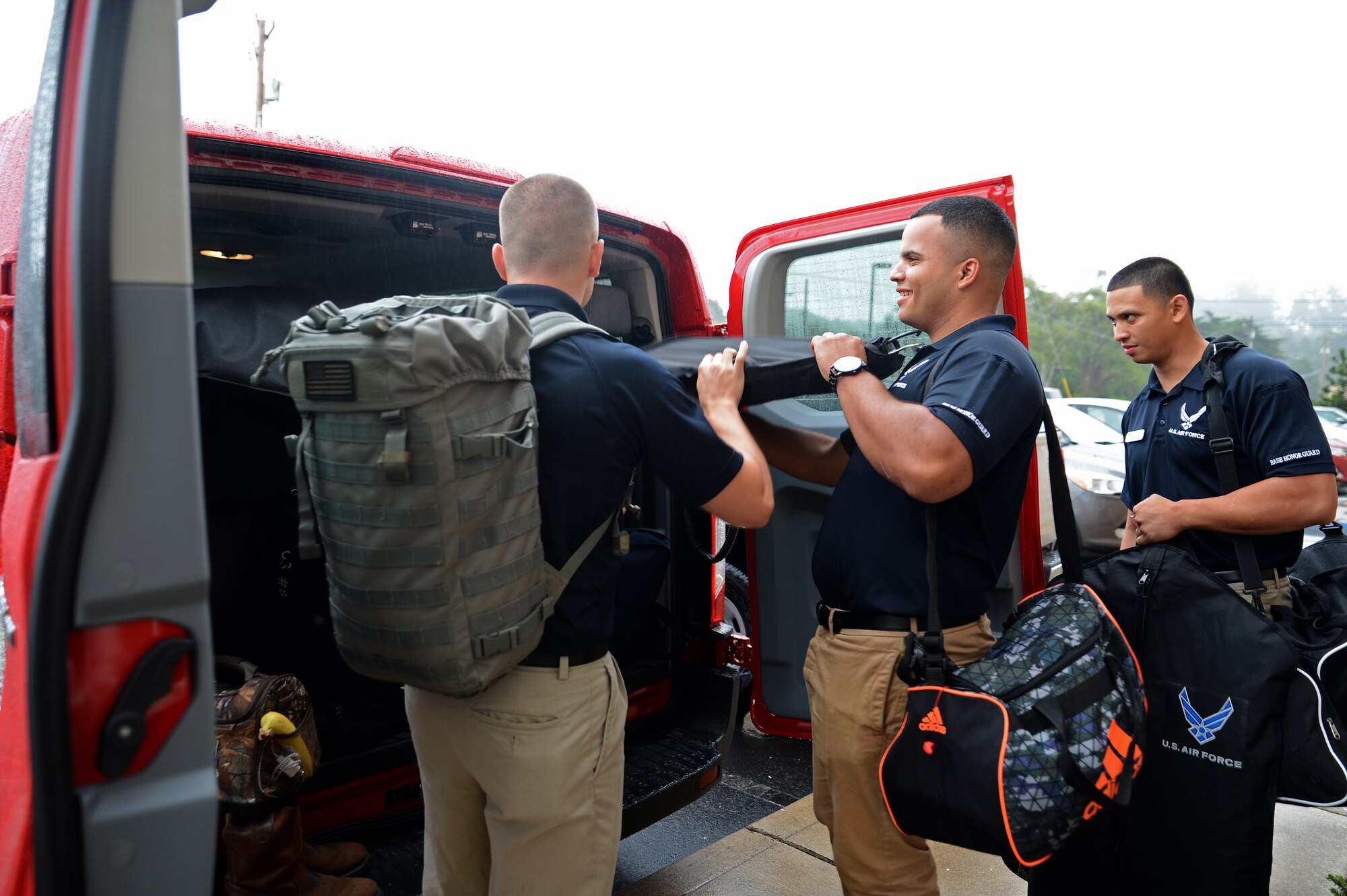 From left to right, Airman 1st Class Shawn Kalmbach, Senior Airman Angel Laureano, and Airman 1st Class Paolo Rivera, members from the McChord Field Honor Guard pallbearer team, load their uniforms into a van July 25, 2015, in Waldport, Ore. The McChord Field Honor Guard performs many ceremonies such as retirements and funerals in the Pacific Northwest. (U.S. Air Force photo/Airman 1st Class Keoni Chavarria)