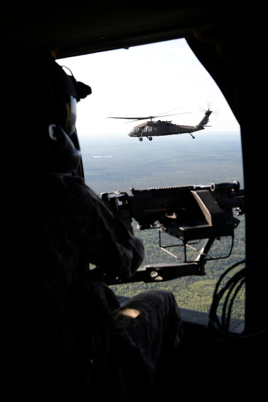 Soldiers from Bravo Company, 1-147 Aviation, Michigan National Guard support soldiers from Alpha Company, 125th Infantry Regiment, Michigan National Guard conduct an infiltration/exfiltration mission at Grayling Joint Maneuver Training Center July 23, 2015, as part of Exercise Northern Strike 15. Northern Strike 15 will combine ground and air capabilities that will bring together aircraft from more than a dozen units and service members from 25 states and four coalition countries from July 23 to Aug. 1 on Camp Grayling, Alpena and in Rogers City. Northern Strike is the only exercise of this size and scope for the Michigan Guard and will integrate ground-based weapon systems like mortars and artillery with attack aircraft to support maneuver forces on the ground. (U.S. Air Force photo by Staff Sgt. Matthew B.Fredericks/Released)
