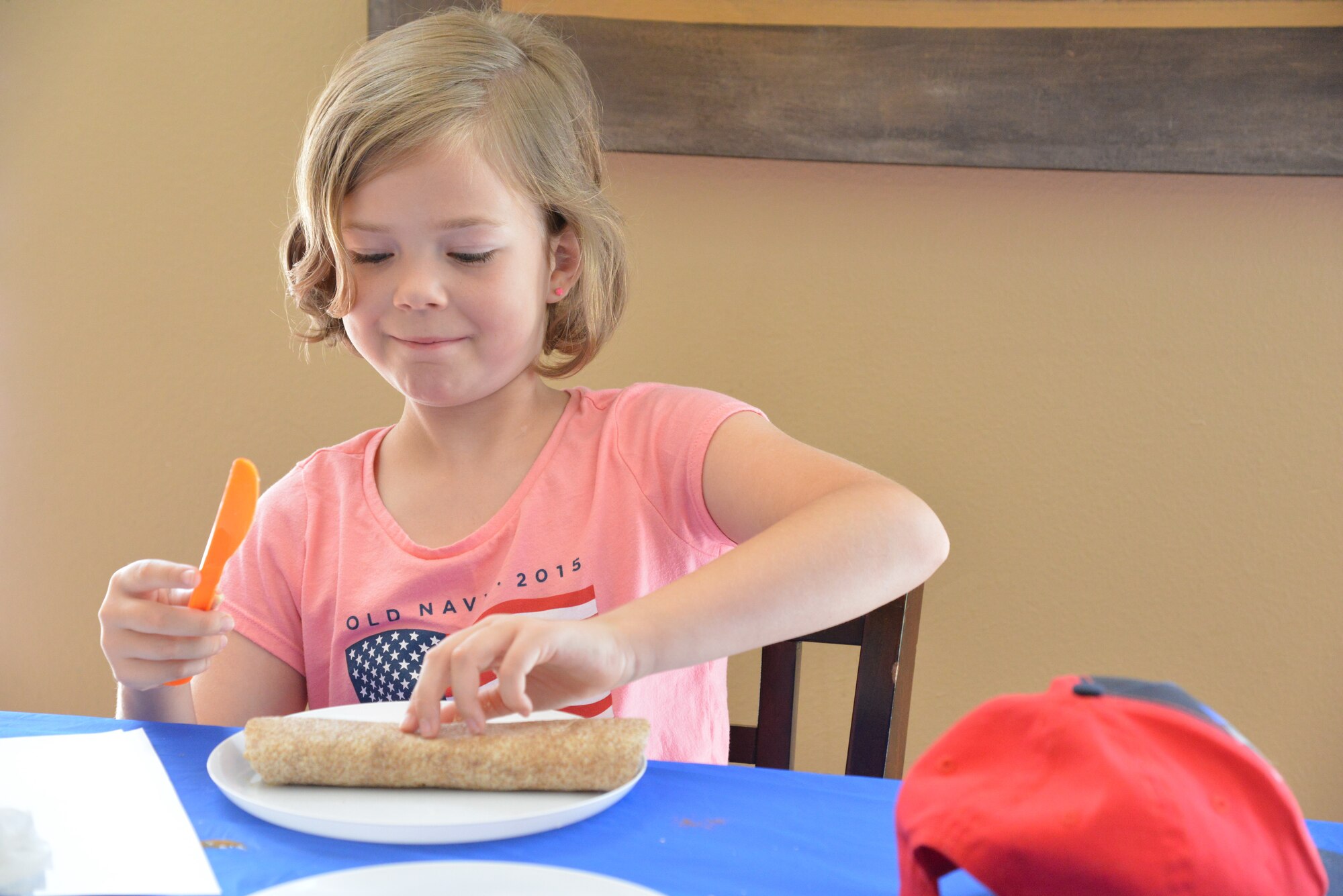 A young chef works on her plating during a “Cooking with Kids” class hosted by Kirtland Family Housing July 15. (Photo by Jamie Burnett)