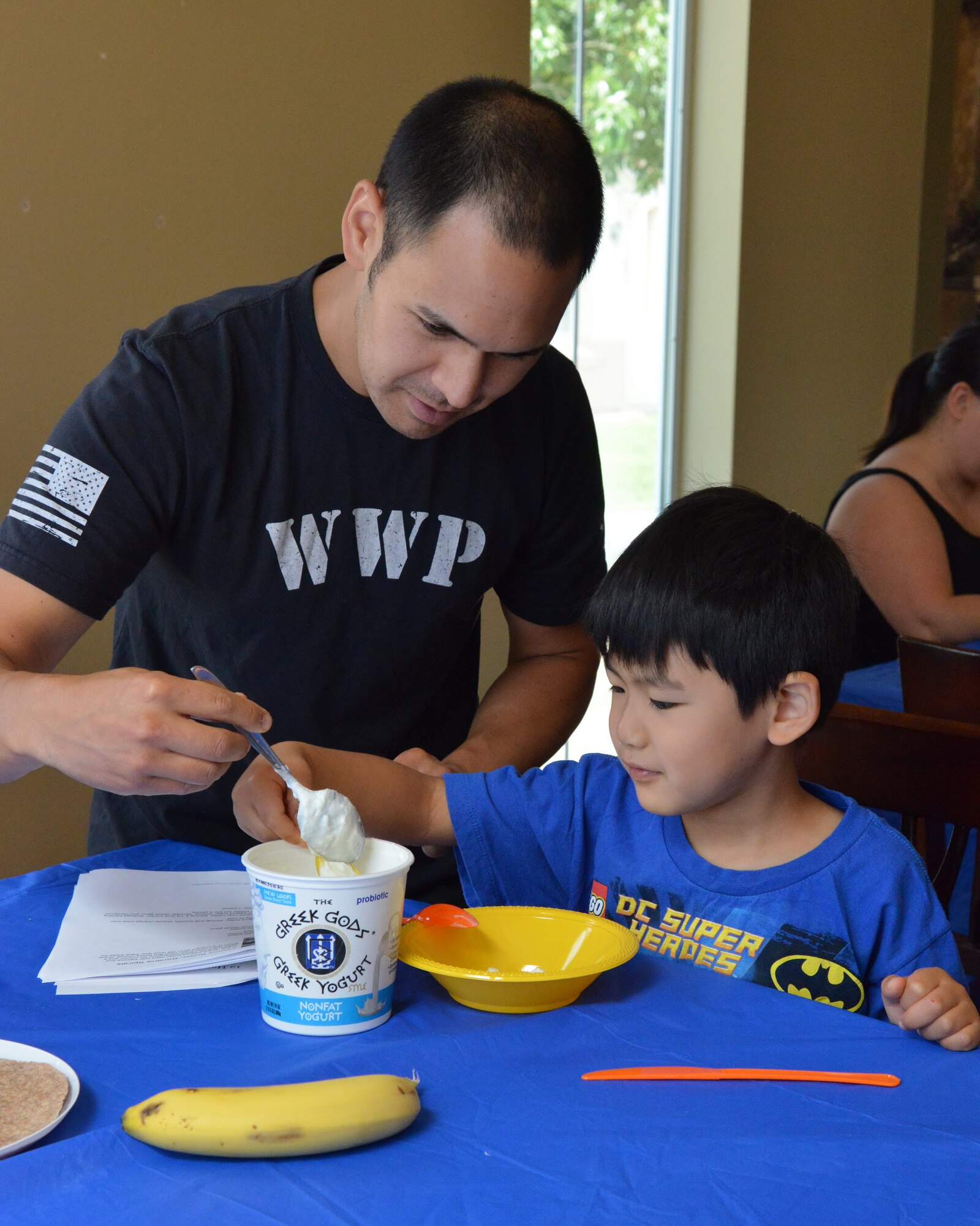 Maj. Kenji Harrop and his son, Parker, 5, make a simple, healthy snack together during the “Cooking with Kids” class. Harrop works at the Air Force Inspection Agency.  (Photo by Jamie Burnett)