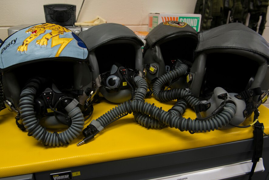 Flight helmets from 81st Fighter Squadron pilots rest on a table before an A-29 Super Tucano flight with U.S. Air Force Maj. Gen. H. D. Polumbo Jr., Ninth Air Force commander, July 23, 2015, at Moody Air Force Base, Ga. Polumbo flew the A-29, a light air support training aircraft used to train Afghan pilots and Afghan maintainers. (U.S. Air Force photo by Airman 1st Class Kathleen D. Bryant/Released)

