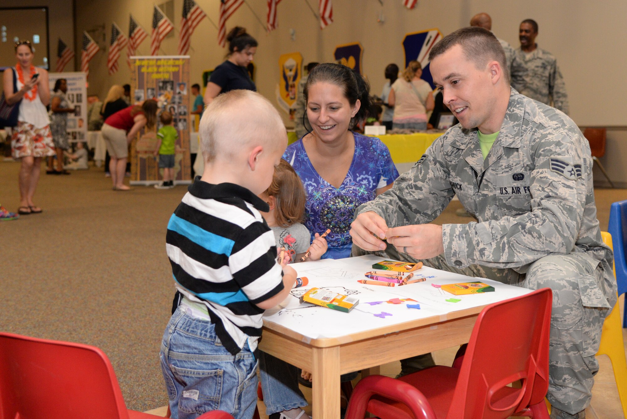 Senior Airman Benjamin Shuck, 608th Air Communications Squadron network infrastructure technician, enjoys the children area with his family during the 7th Annual Multicultural Day event at Barksdale Air Force Base, La., July 24, 2015. The emphasis of the event was to educate attendees on different cultures and lifestyles in a fun way. (U.S. Air Force photo/Senior Airman Jannelle Dickey)