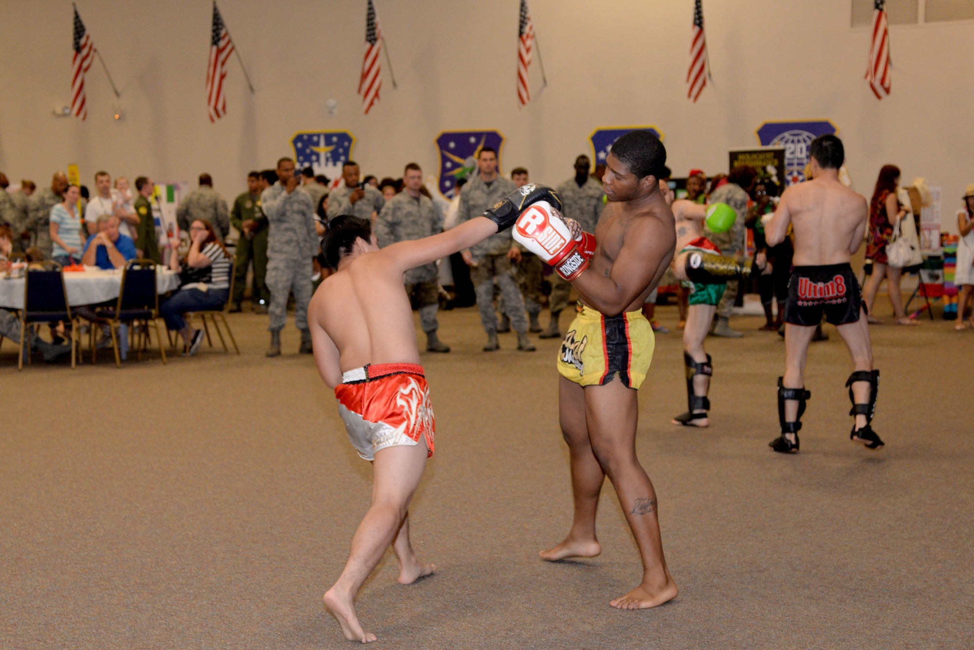 Tankhead Fight Club members demonstrate Muay Thai boxing during the 7th Annual Multicultural Day event at Barksdale Air Force Base, La., July 24, 2015. The performers showcased various striking techniques and take down moves for close combat fighting. (U.S. Air Force photo/Senior Airman Jannelle Dickey)
