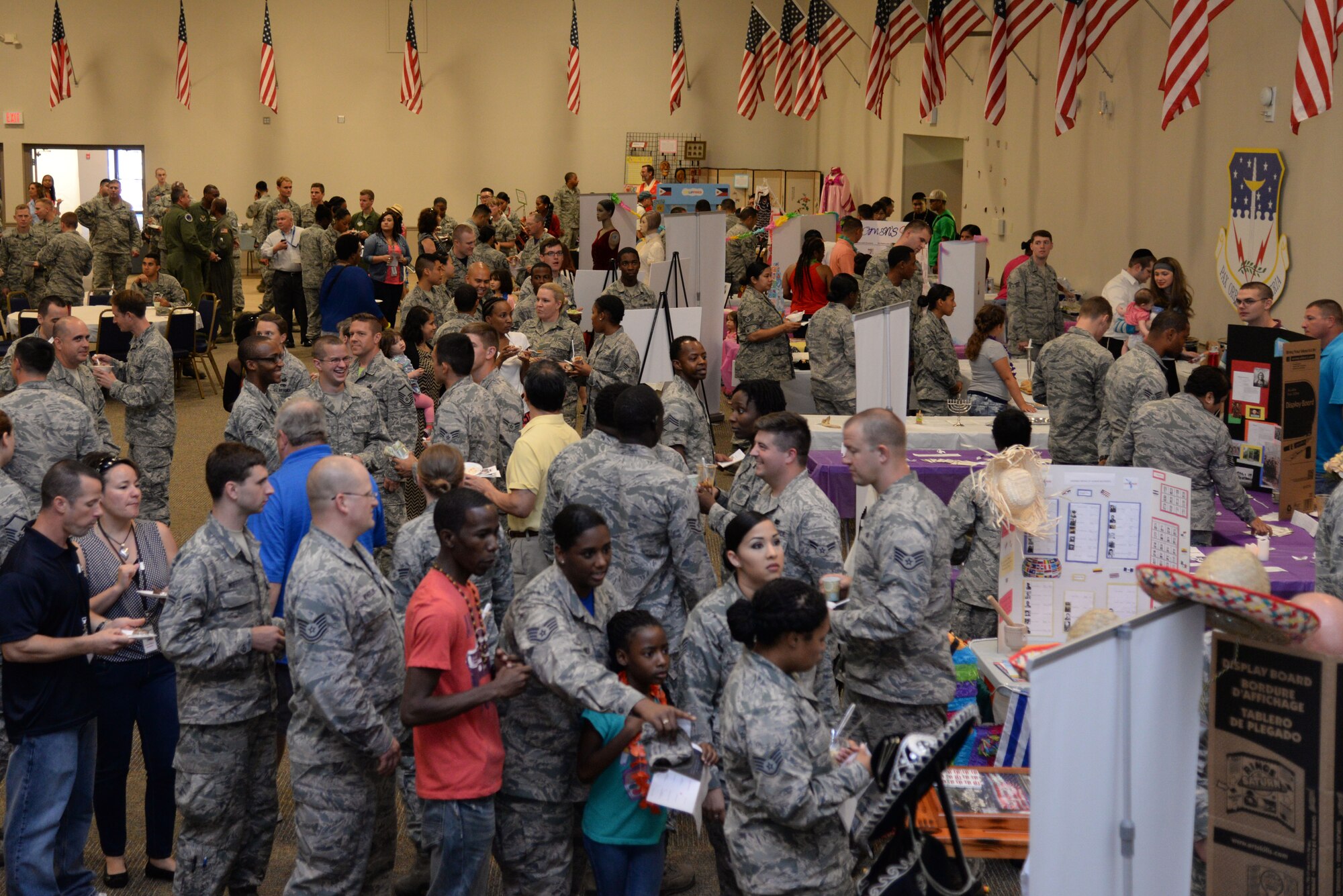 Team Barksdale Airmen tour booths at the 7th Annual Multicultural Day event at Barksdale Air Force Base, La., July 24, 2015. More than 600 guests were in attendance. (U.S. Air Force photo/Senior Airman Jannelle Dickey)