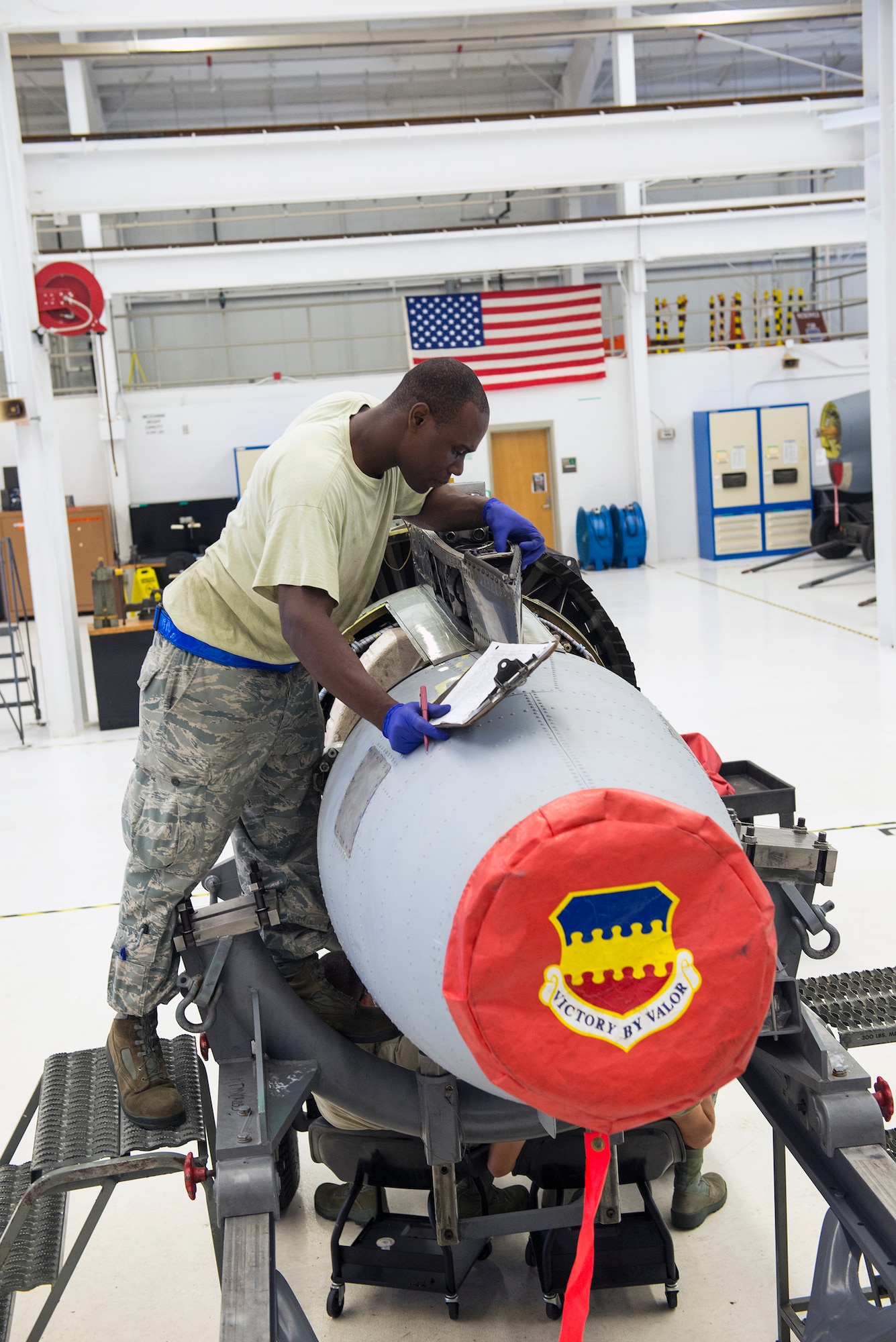 U.S. Air Force Staff Sgt. Gladstone Edwards, 23d Component Maintenance Squadron aerospace propulsion craftsman, inspects a TF-34 engine for discrepancies July 27, 2015, at Moody Air Force Base, Ga. After the TF-34 back shop conducts multiple inspections, quality assurance personnel from the 23d Maintenance Group perform a final inspection to signify completion of the ‘war ready’ engine. (U.S. Air Force photo by Airman Greg Nash/Released)  