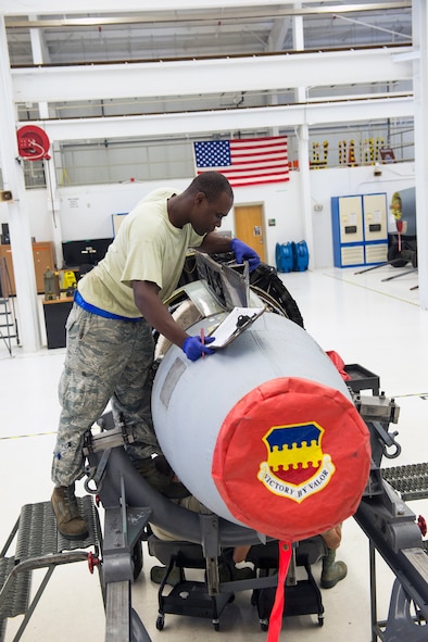 U.S. Air Force Staff Sgt. Gladstone Edwards, 23d Component Maintenance Squadron aerospace propulsion craftsman, inspects a TF-34 engine for discrepancies July 27, 2015, at Moody Air Force Base, Ga. After the TF-34 back shop conducts multiple inspections, quality assurance personnel from the 23d Maintenance Group perform a final inspection to signify completion of the ‘war ready’ engine. (U.S. Air Force photo by Airman Greg Nash/Released)  
