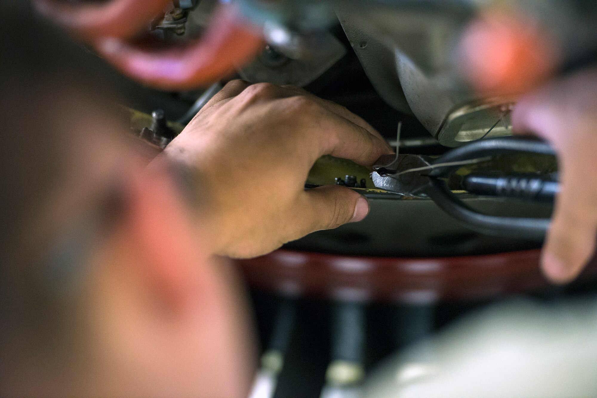 U.S. Air Force Airman 1st Class Chris Umeck, 23d Component Maintenance Squadron aerospace propulsion apprentice, twists safety wire into bolts on a TF-34 engine July 27, 2015, at Moody Air Force Base, Ga. The 23d CMS Propulsion Flight has reduced the amount of time for the high-pressure turbine stage-one blade rebuild by 13 days. Accomplishing a successful engine completion usually takes 28 days. (U.S. Air Force photo by Airman Greg Nash/Released)   