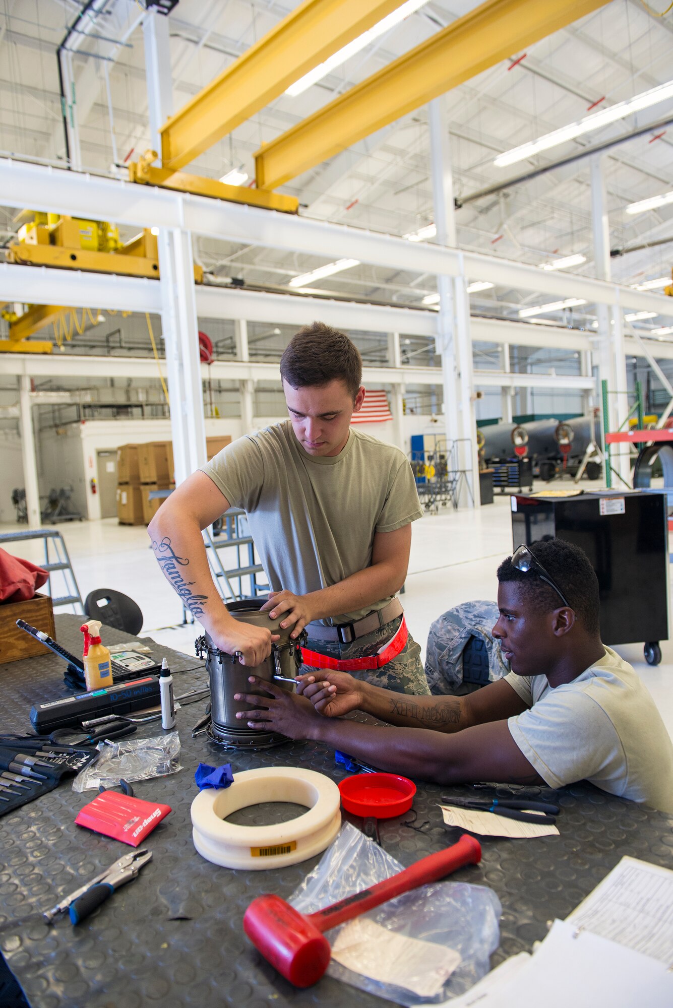 U.S. Air Force Airmen 1st Class Donald Matts, (left), and Jelani Ivory, 23d Component Maintenance Squadron aerospace propulsion apprentices, install a No. 4 bearing into a b-sump housing property for a TF-34 engine July 27, 2015, at Moody Air Force Base, Ga. The 23d CMS Propulsion Flight is responsible for receiving, efficiently breaking down, and repairing TF-34’s. (U.S. Air Force photo by Airman Greg Nash/Released) 