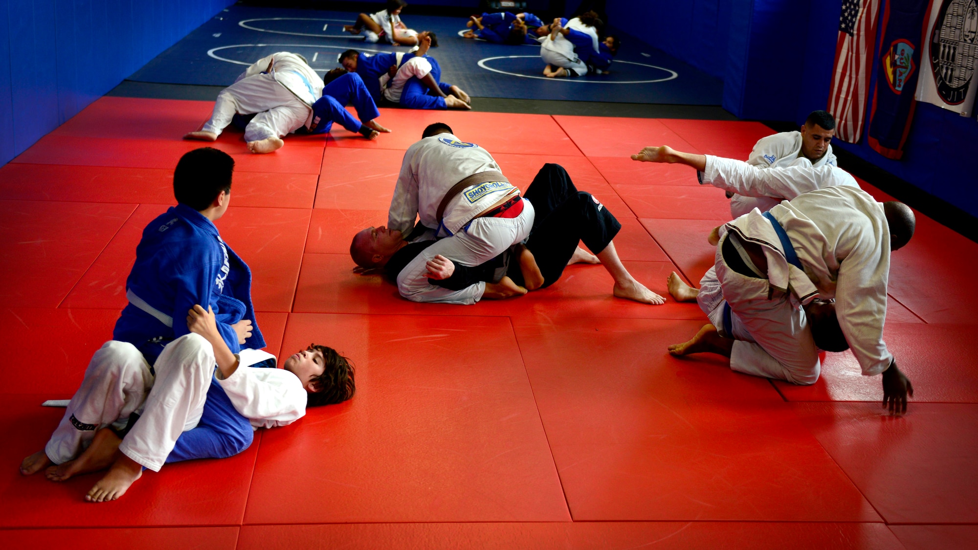 Jiu Jitsu Class students practice grappling techniques, July 27, 2015, at Aviano Air Base, Italy. Jiu jitsu teaches members how to defeat their opponents using joint locks and chokeholds. (U.S. Air Force photo by Senior Airman Areca T. Wilson/Released)