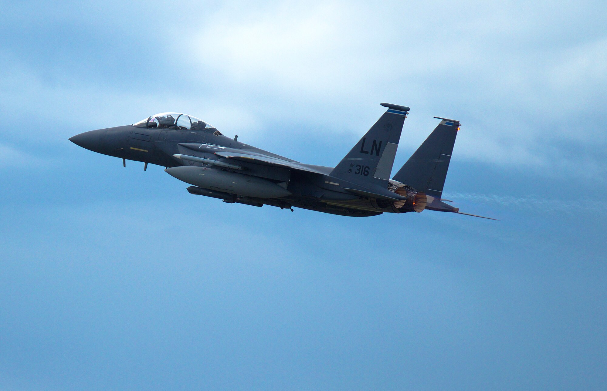 An F-15E Strike Eagle, assigned to the 492nd Fighter Squadron, soars over Royal Air Force Lakenheath, England, July 28, 2015. The 48th Fighter Wing produces an average of 32 sorties throughout the day to maintain training requirements, with mission preparations beginning very early in the morning. (U.S. Air Force photo by Senior Airman Trevor T. McBride/Released) 