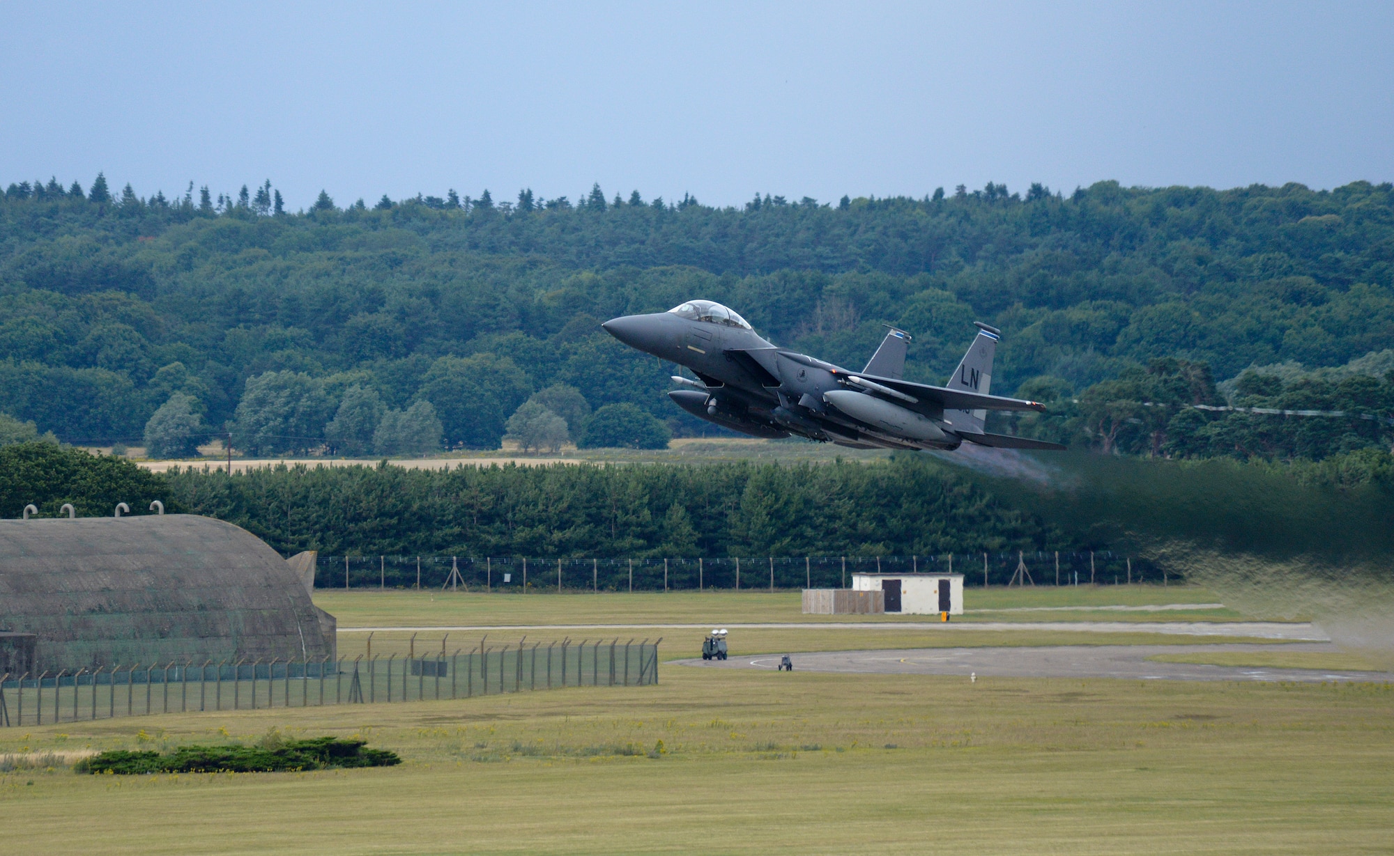 An F-15E Strike Eagle, assigned to the 492nd Fighter Squadron, takes off from Royal Air Force Lakenheath, England, July 28, 2015. The 48th Fighter Wing produces an average of 32 sorties throughout the day to maintain training requirements, with mission preparations beginning very early in the morning. (U.S. Air Force photo by Senior Airman Trevor T. McBride/Released)  