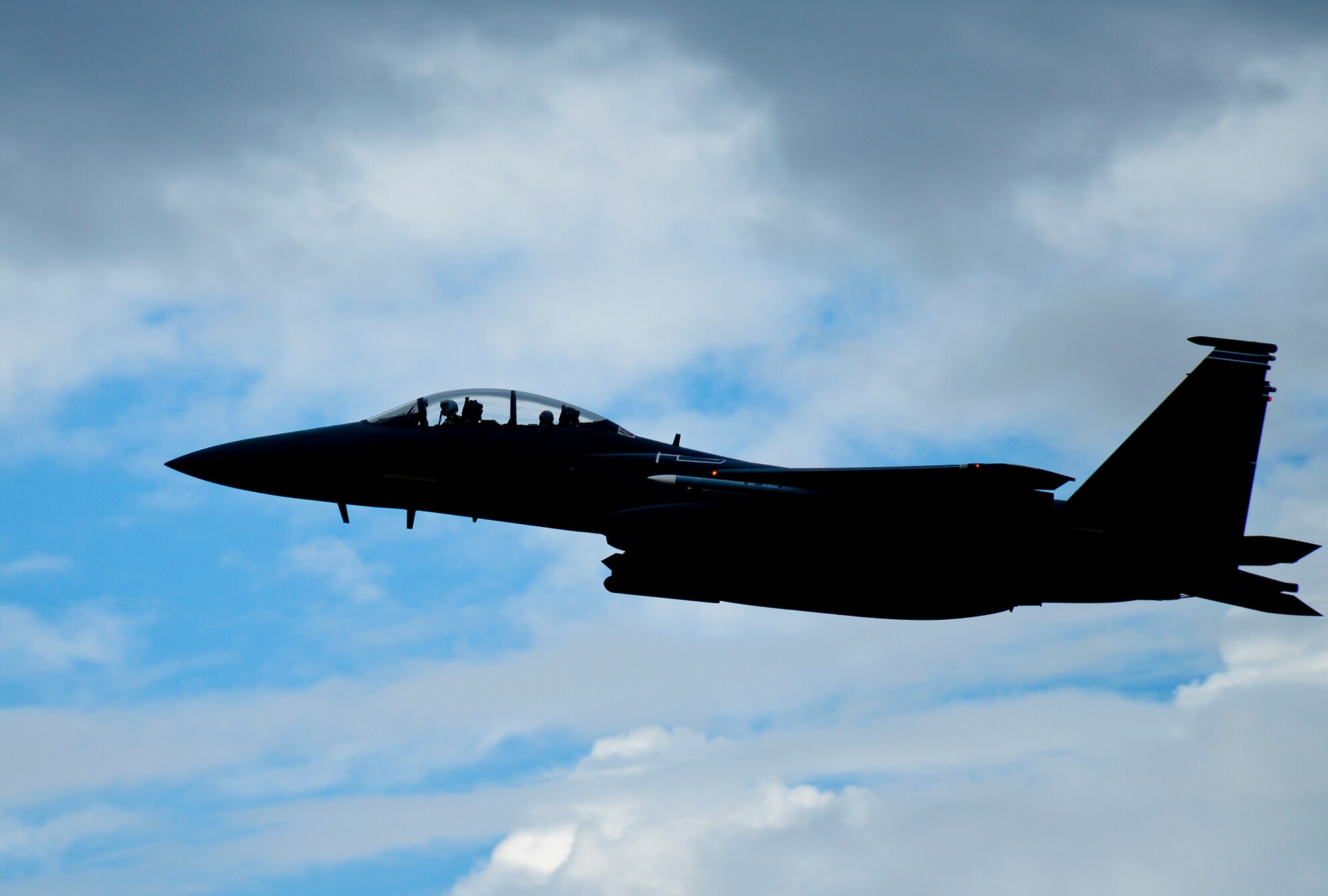 An F-15E Strike Eagle, assigned to the 492nd Fighter Squadron, soars over Royal Air Force Lakenheath, England, July 28, 2015. The 48th Fighter Wing produces an average of 32 sorties throughout the day to maintain training requirements, with mission preparations beginning very early in the morning. (U.S. Air Force photo by Senior Airman Trevor T. McBride/Released)  