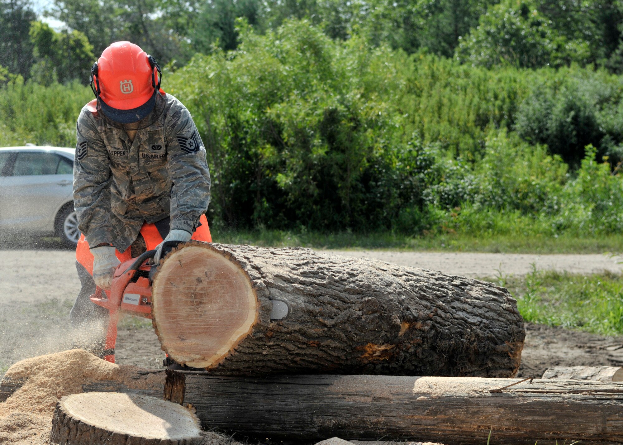 Tech. Sgt. Derek Leppek, structures supervisor, 127th Civil Engineering Squadron, Selfridge Air National Guard Base, Mich., cuts tree logs into pieces during the PATRIOT 2015 exercise at Volk Field, Wis., July 22, 2015. PATRIOT is an annual exercise held at Volk Field to test the National Guard’s capabilities and develop working relationships with first responders and government agencies. (U.S. Air National Guard photo by Senior Airman Justin Andras/Released)