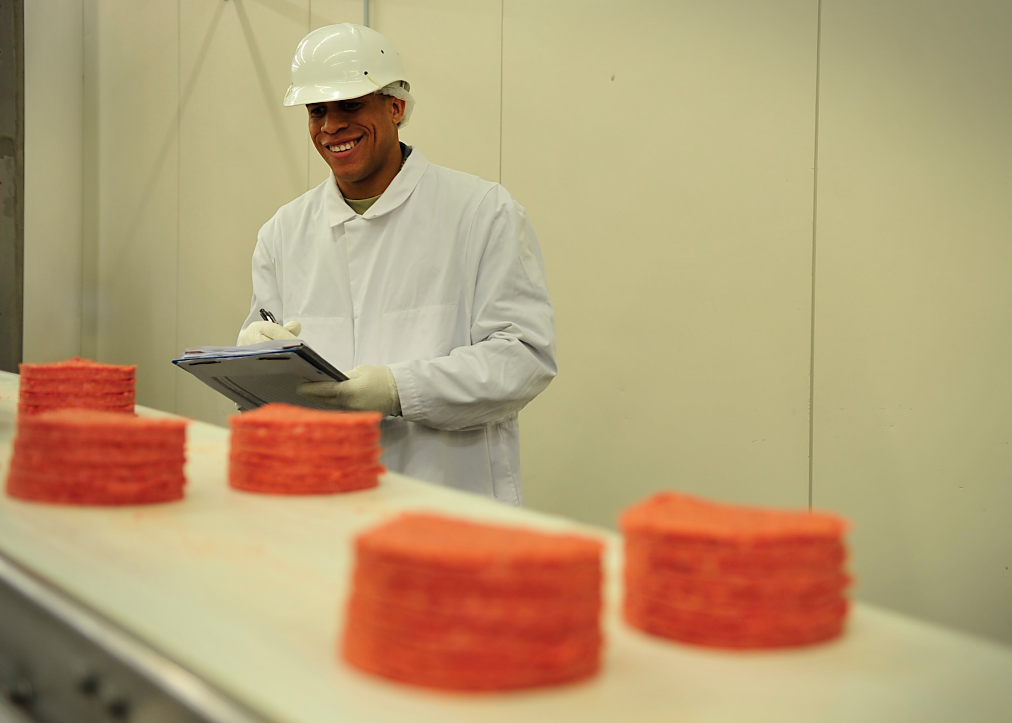 Senior Airman Allen R. Cherry III, 86th Aerospace Medicine Squadron Public Health technician, inspects meat patties at the meat distribution center June 29, 2015, at Ramstein Air Base, Germany. Cherry was officially announced one of the 12 Outstanding Airmen of the Year on July 27. (U.S. Air Force photo/Airman 1st Class Larissa Greatwood)