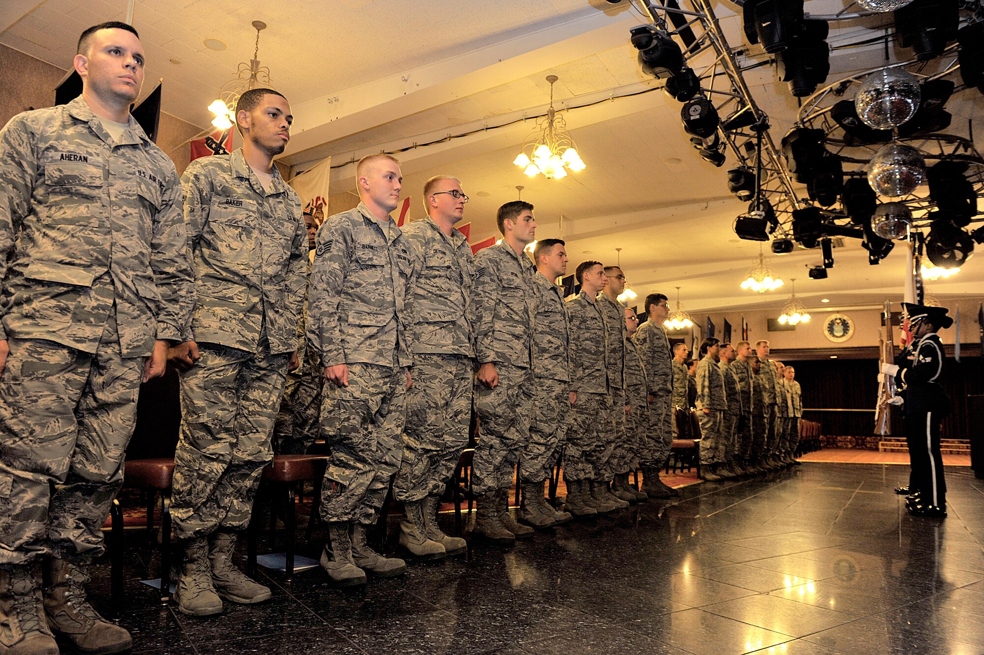 U.S. Air Force staff sergeants honor the colors during a NCO induction ceremony at the Rocker NCO Club on Kadena Air Base, Japan, July 28, 2015. The NCO induction ceremony is a celebration of the newly promoted joining the ranks of professional NCO and it recognizes individuals who have attained the rank of staff sergeant, marking their transition to a leadership role. (U.S. Air Force photo by Naoto Anazawa)
