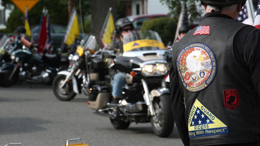 Members of the Patriot Guard Riders motorcycle club line the streets for Gunnery Sgt. Thomas J. Sullivan’s funeral procession outside Holy Cross Church in Springfield, Massachusetts, July 27, 2015. Sullivan was one of five victims of the Chattanooga, Tennessee shootings July 16, 2015. The Patriot Guard led the way in the procession with more than 100 riders bearing American and Marine Corps flags to honor the fallen hero. 