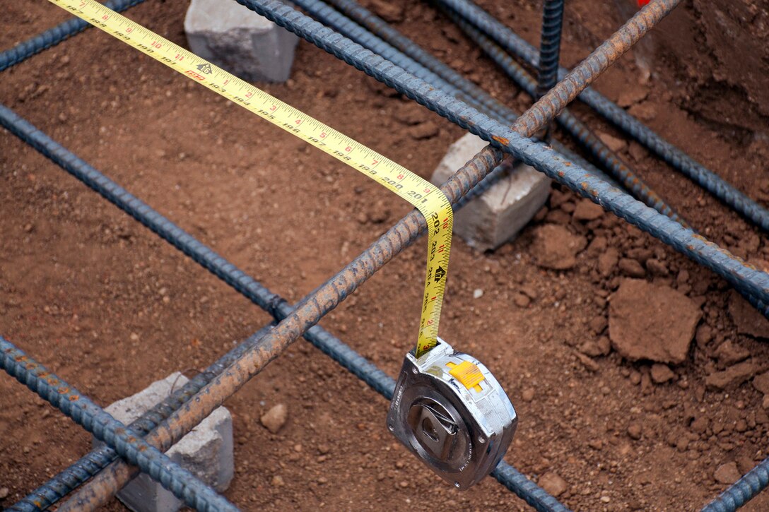 A tape measure marks the length for additional rebar on a civil-military Innovative Readiness Training (IRT) project in San Marcos, Calif., June 9, 2015. The IRT Program gives Air Force RED HORSE personnel real-world, hands-on-training, and more precision work experience than most on-station training can provide. (U.S. Air Force photo by Master Sgt. Jeff Walston) 