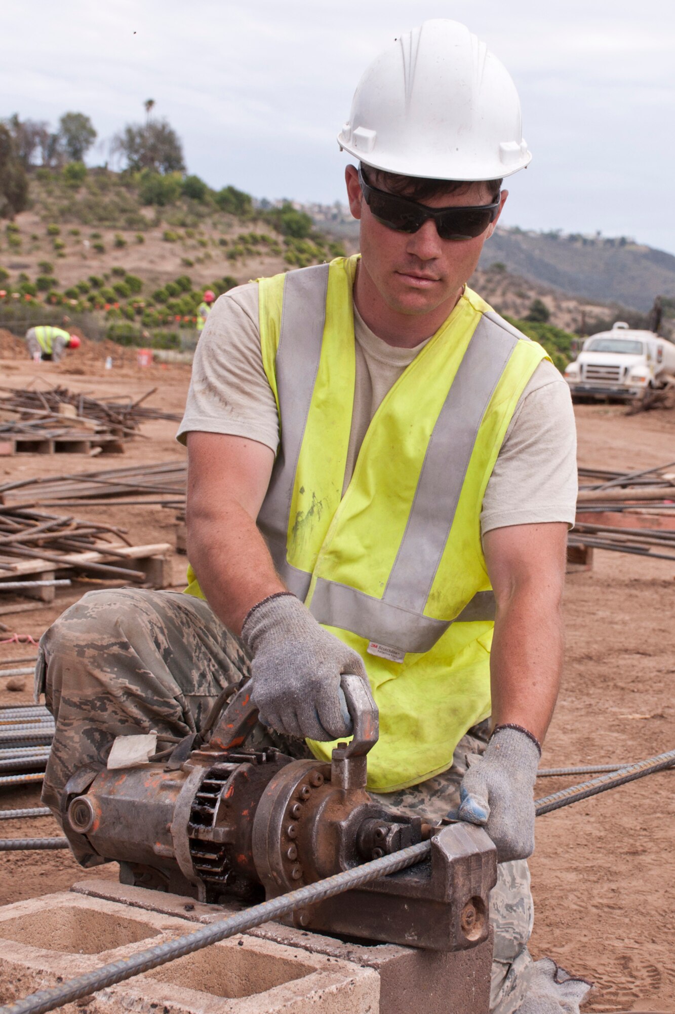 U.S. Air Force Senior Airman Trevor J. Wolfe, a structural journeyman assigned to the 583rd RED HORSE at Beale Air Force Base, Calif., cuts rebar for structural support in a perimeter wall being constructed in San Marcos, Calif., June 9, 2015. The project is for Training, Education, Research and Innovation (TERI) Inc., a non-profit organization dedicated to the education and assistance for children/adults with Autism and other special needs. (U.S. Air Force photo by Master Sgt. Jeff Walston)