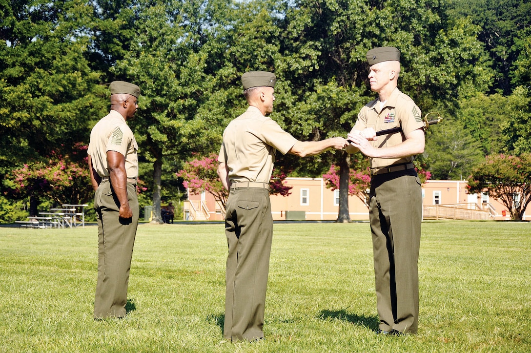 From left: Sgt. Maj. Gerald A. Saunders, outgoing, and Col. Todd J. Oneto, Commander of the Headquarters and Service Battalion, welcomes Sgt. Maj. Thomas L. Johnson, incoming H&S Bn. sergeant major during a relief and appointment ceremony July 24, here. Johnson previously served with the Combat Logistics Battalion 23, Joint Base Lewis McCord, Wash. as the Inspector-Instructor Sergeant Major.