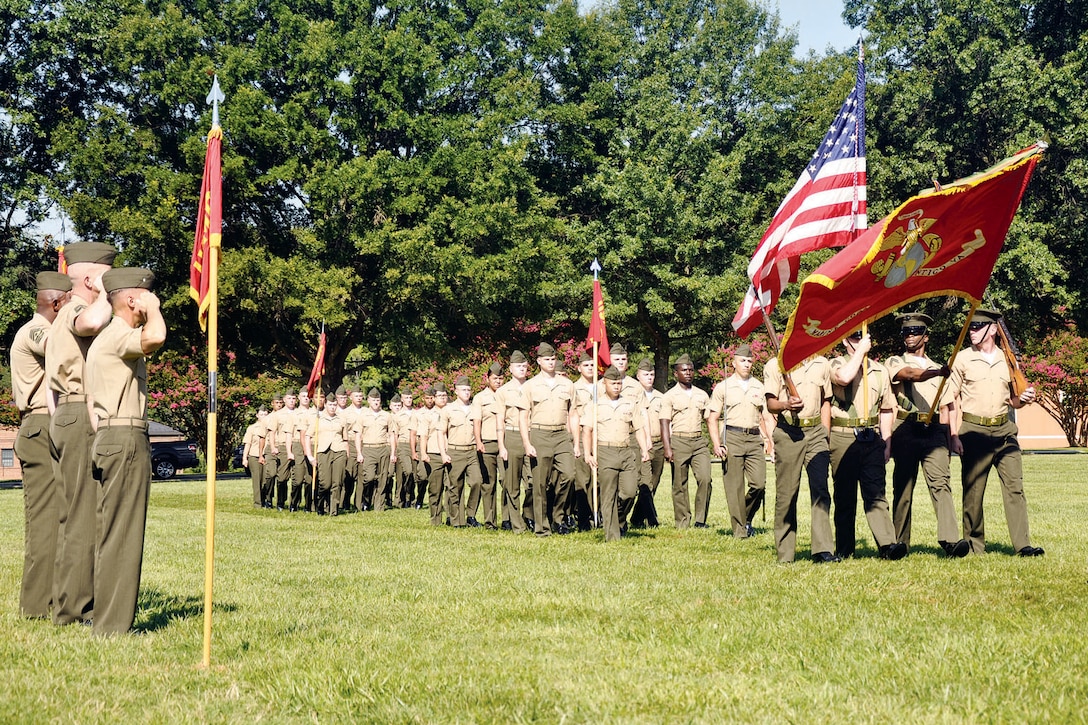 A group of enlisted Marines form a battalion staff platoon during the relief and appointment ceremony for Headquarters and Service Battalion July 24, here.