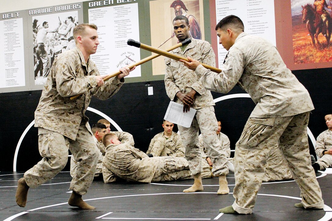 Marines train in close quarters combat using mock rifles and bayonets during a three-week Marine Corps Martial Arts Program Instructors Course in Raider Hall at The Basic School July 25. Marines have used these bayonet techniques combined with unarmed combat technique since World War II.