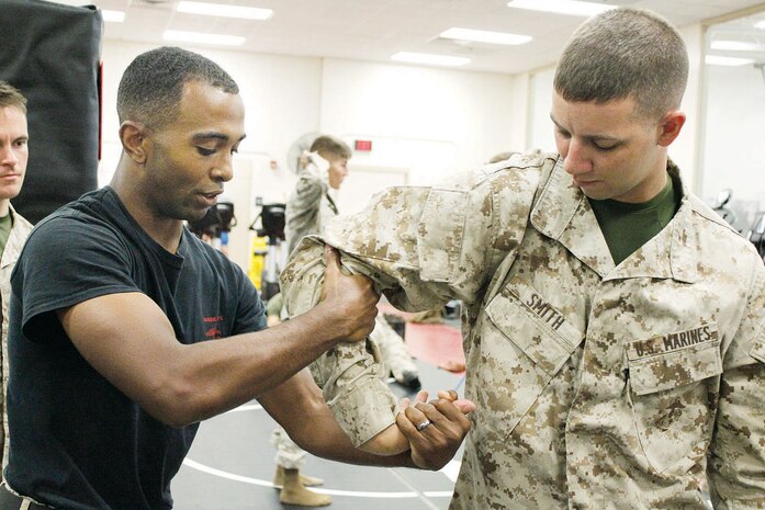 Sgt. Carey Edwards, (left) trains 2nd Lt. Zachary Smith, a native of Arcanum, Ohio, in close combat hand-to-hand techniques. The training increases combat efficiency and reasonable application of force.