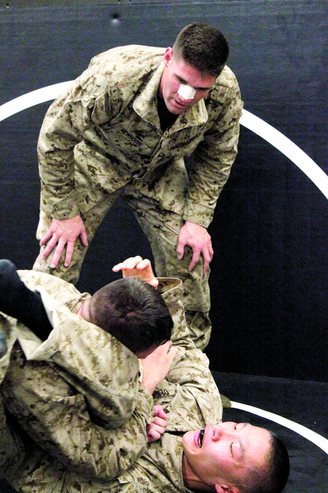 Second Lt. Matthew C. Newhouse, (top) Marine Corps reservist from Los Angeles, observes a two-man spar July 24, during the instructor’s course at the Martial Arts Center of Excellence in Raider Hall at The Basic School.
