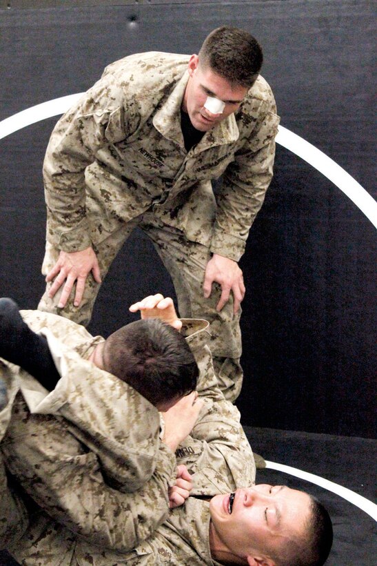 Second Lt. Matthew C. Newhouse, (top) Marine Corps reservist from Los Angeles, observes a two-man spar July 24, during the instructor’s course at the Martial Arts Center of Excellence in Raider Hall at The Basic School.