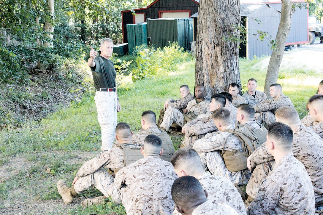 Retired Lt. Col. Joe Shusko, deputy director of Martial Arts Center of Excellence, tells war stories to remind Marines about the importance of character following physical training during a three-week Marine Corps Martial Arts Program instructor’s course July 22 in Raider Hall at The Basic School.