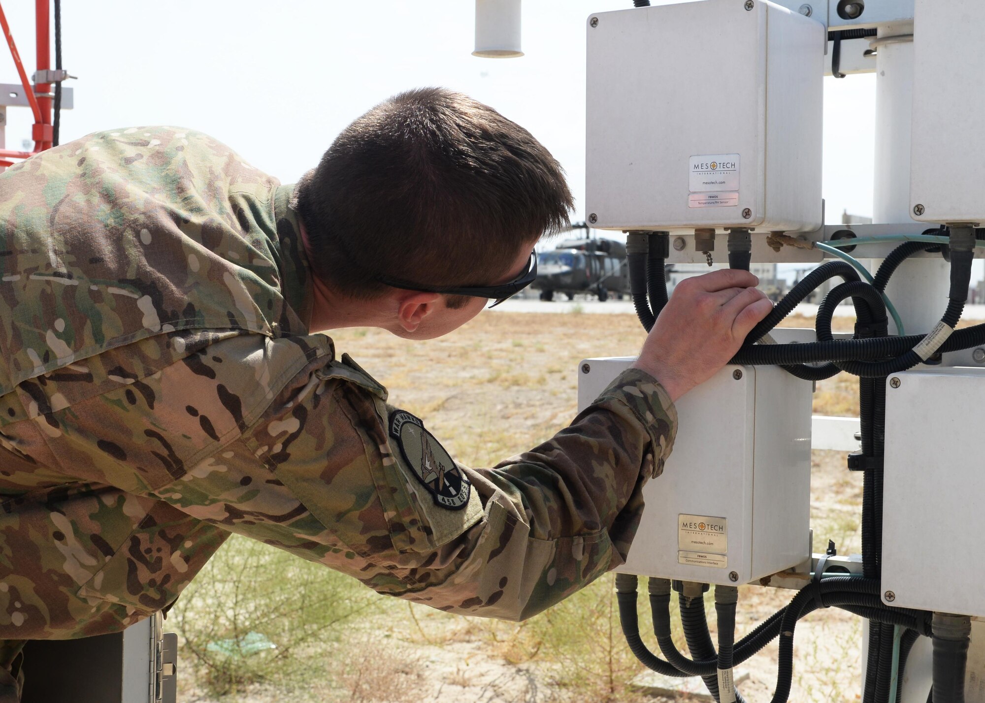 U.S. Air Force Staff Sgt. Travis Luzania, 455th Expeditionary Operations Support Squadron quality assurance evaluator, inspects a machine July 22, 2015, at Bagram Airfield, Afghanistan. Luzania is responsible for checking the work performed by contractors to ensure all equipment and programs are managed properly at all times. (U.S. Air Force photo by Senior Airman Cierra Presentado/Released)