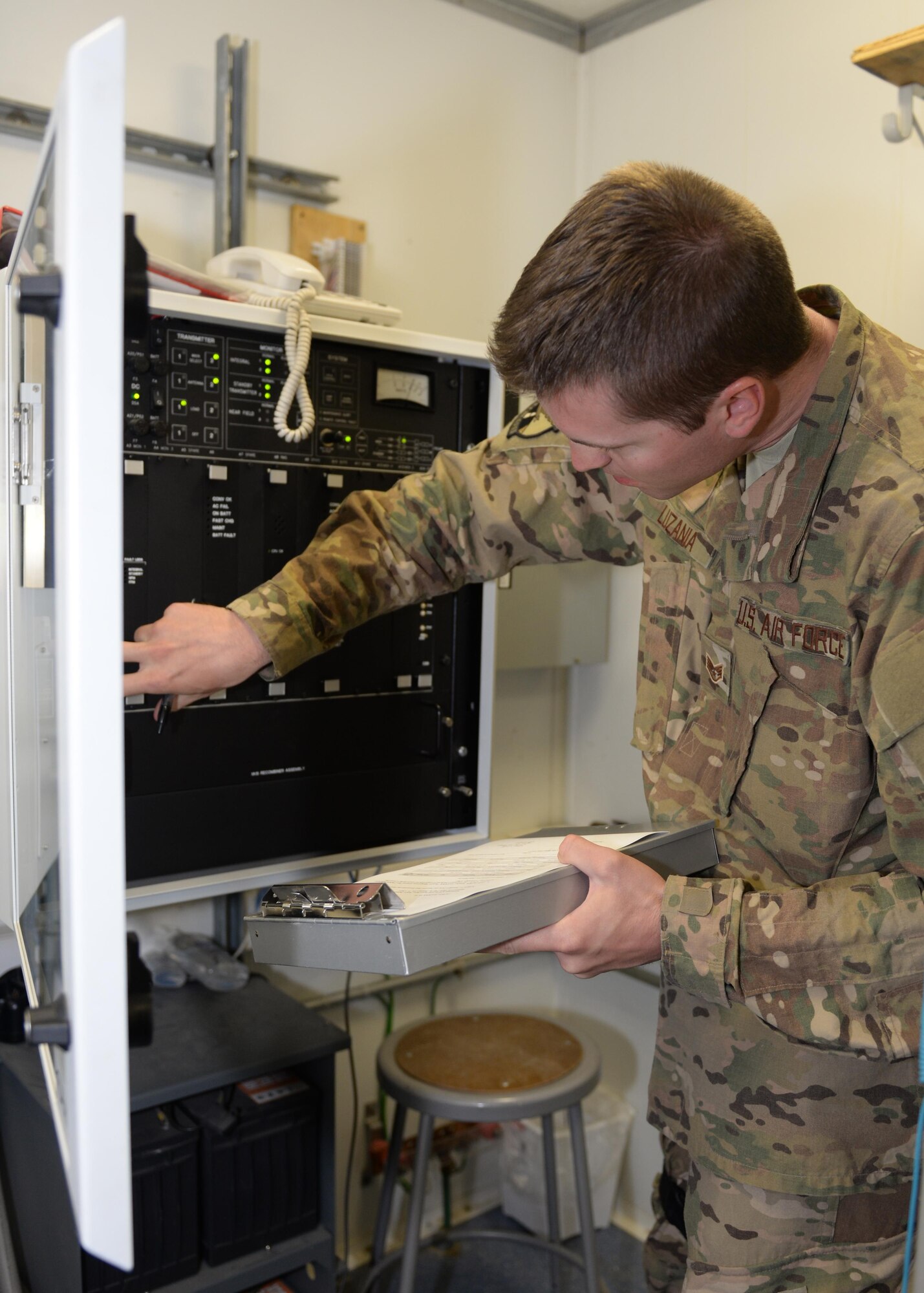 U.S. Air Force Staff Sgt. Travis Luzania, 455th Expeditionary Operations Support Squadron quality assurance evaluator, inspects a machine July 22, 2015, at Bagram Airfield, Afghanistan. Luzania is responsible for checking the work performed by contractors to ensure all equipment and programs are managed properly at all times. (U.S. Air Force photo by Senior Airman Cierra Presentado/Released)