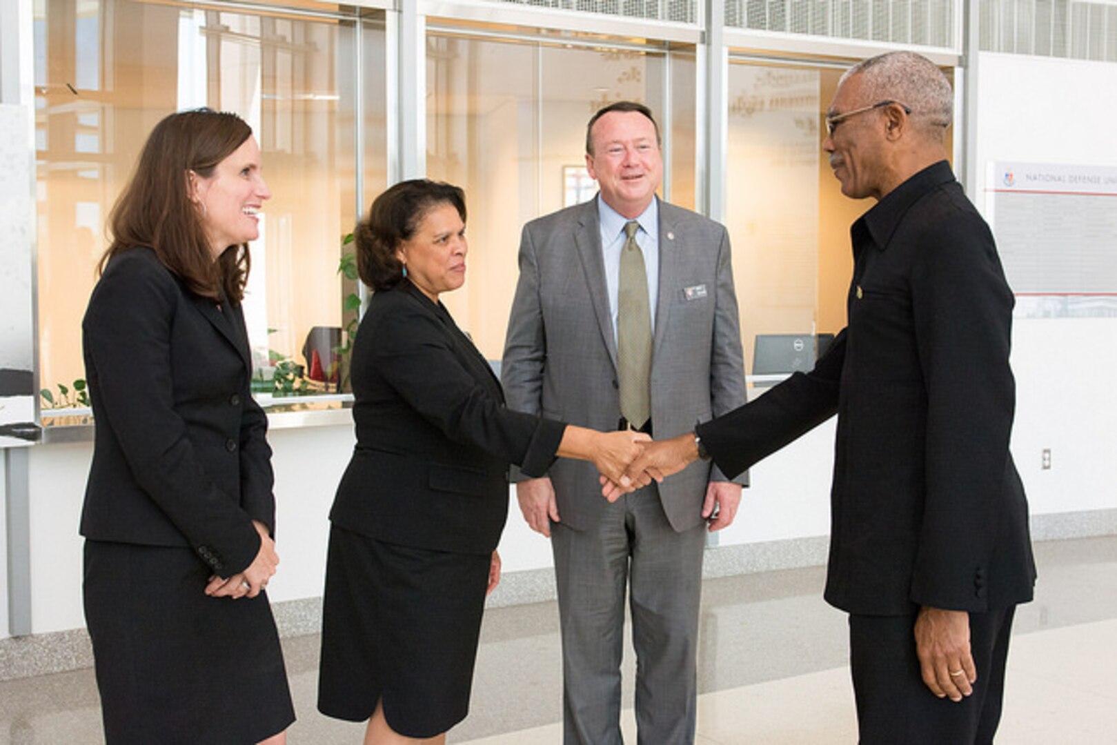President Granger is greeted by NDU Senior Vice President Ambassador Wanda Nesbitt and Perry Center Director Mark Wilkins