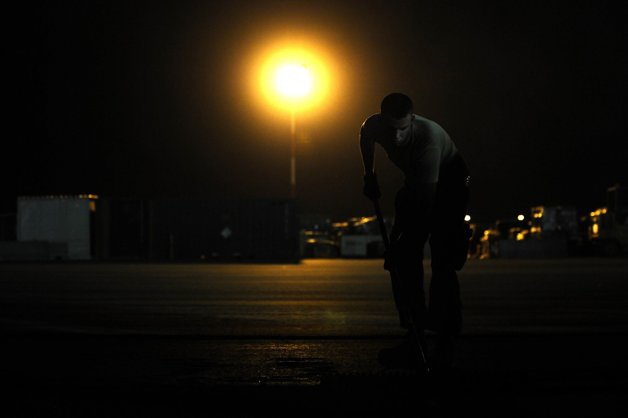 Members of the 820th RED HORSE pave an aircraft runway July 29, 2015 at an undisclosed location in Southwest Asia. Most work involving asphalt in the area is accomplished at night so it can cool and set properly without potential problems from excessive heat during daylight hours. (U.S. Air Force photo by Tech. Sgt. Brittany E. Jones)