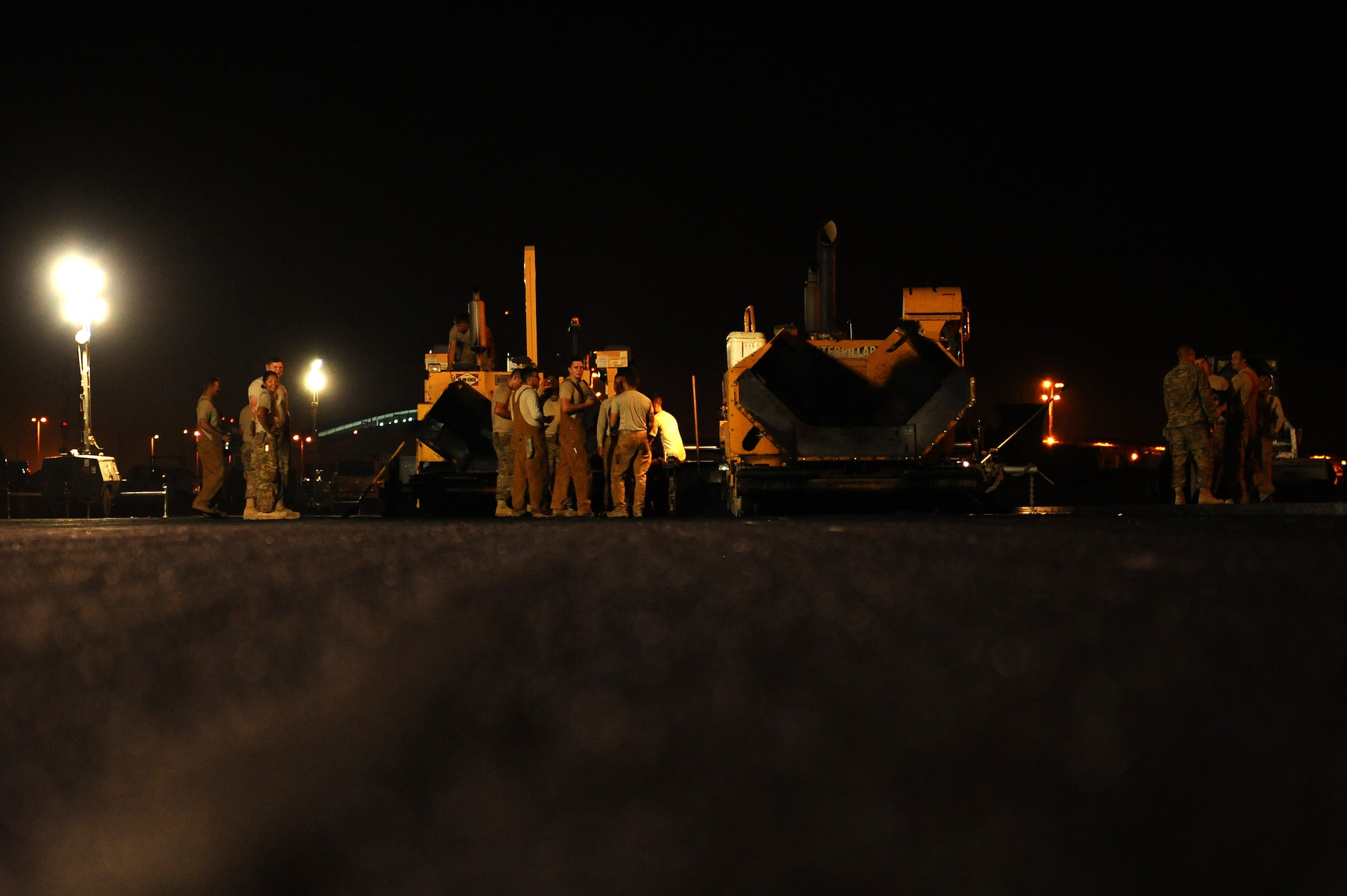 Members of the 820th RED HORSE pave an aircraft runway July 29, 2015 at an undisclosed location in Southwest Asia. The squadron is a self-sufficient civil engineer and logistics unit in the region providing rapid response and independent operations in support of Operation INHERENT RESOLVE. (U.S. Air Force photo by Tech. Sgt. Brittany E. Jones)