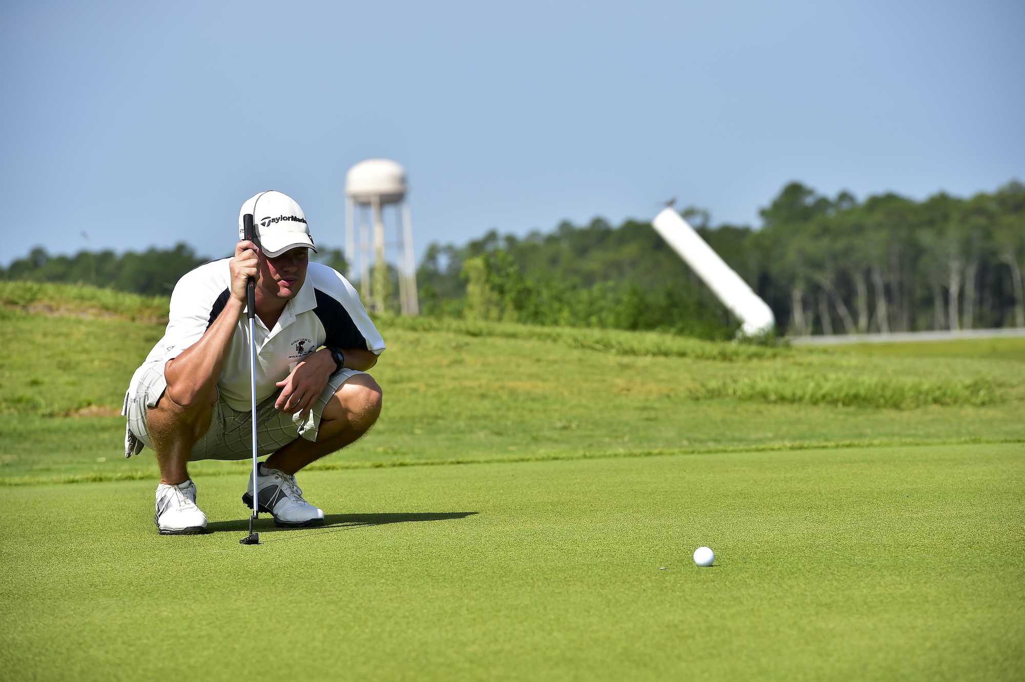 Master Sgt. Chris Raines, Air Force Special Operations Command spectrum manager, lines up his shot during a golf tournament on Hurlburt Field, Fla., July 24, 2015. The golf tournament raised money for the Hurlburt Air Force Ball. (U.S. Air Force photo/Senior Airman Jeff Parkinson)