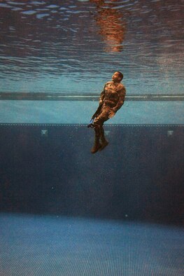 A security forces Airman plunges into the combat water survival test at the U.S. Air Force Academy, Colo., July 17, 2015. The event was part of a daylong course for Airmen across the Front Range area to determine if they are physically and mentally ready to attend the U.S. Army Pre-Ranger Training Assessment Course, a prerequisite to attending U.S. Army Ranger School at Fort Benning, Ga. (U.S. Air Force photo/Jason Gutierrez)