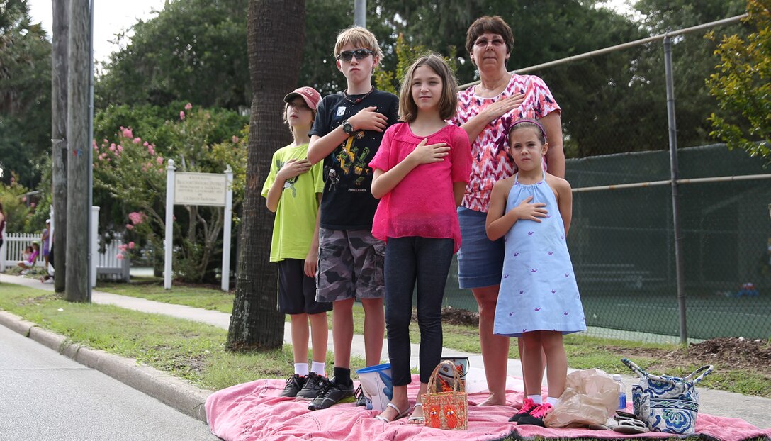 Spectators honor the American flag during the 60th Annual Beaufort Water Festival Parade through downtown Beaufort July 25. The Beaufort Water Festival is one of the largest festivals in the state of South Carolina.