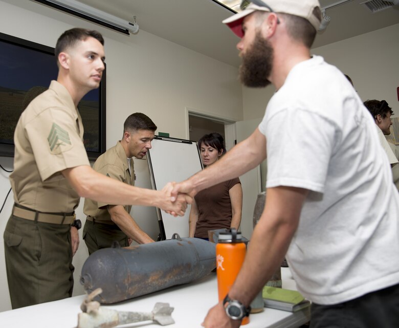 Sgt. Juan Fernandez and Gunnery Sgt. David Dignan, explosive ordnance disposal technicians, answer questions regarding unexploded ordnance at Joshua Tree National Park Headquarters, July 23, 2015. (Official Marine Corps photo by Lance Cpl. Connor Hancock/Released)