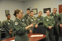Major Erin Shay, 559th Flying Training Squadron flight instructor, briefs Air Force Academy cadets on pilot training during a tour of the squadron July 28, 2015 at Joint Base San Antonio-Randolph.  The 559th FTS provides training for instructor pilots utilizing the T-6 Texan ll aircraft, which is used to teach pilots basic flying skills.  (U.S. Air Force photo by Joel Martinez/Released)