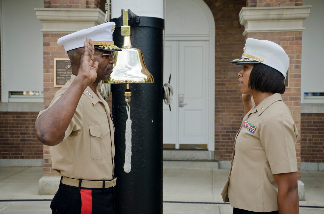 U.S. Marine Corps Maj. Lisa Lawrence, right, recites the Uniformed Services Oath of Office during her promotion ceremony at Marine Barracks Washington, D.C., June 6, 2015. Lawrence, a native of Houston, has served in the Marine Corps for 11 years as a public affairs officer, completing combat tours in both Iraq and Afghanistan. She currently serves as an officer selection officer for Recruiting Station Baltimore, where she is tasked with recruiting highly qualified men and women who desire to become Marine officers. (U.S. Marine Corps photo by Sgt. Bryan Nygaard/Released)