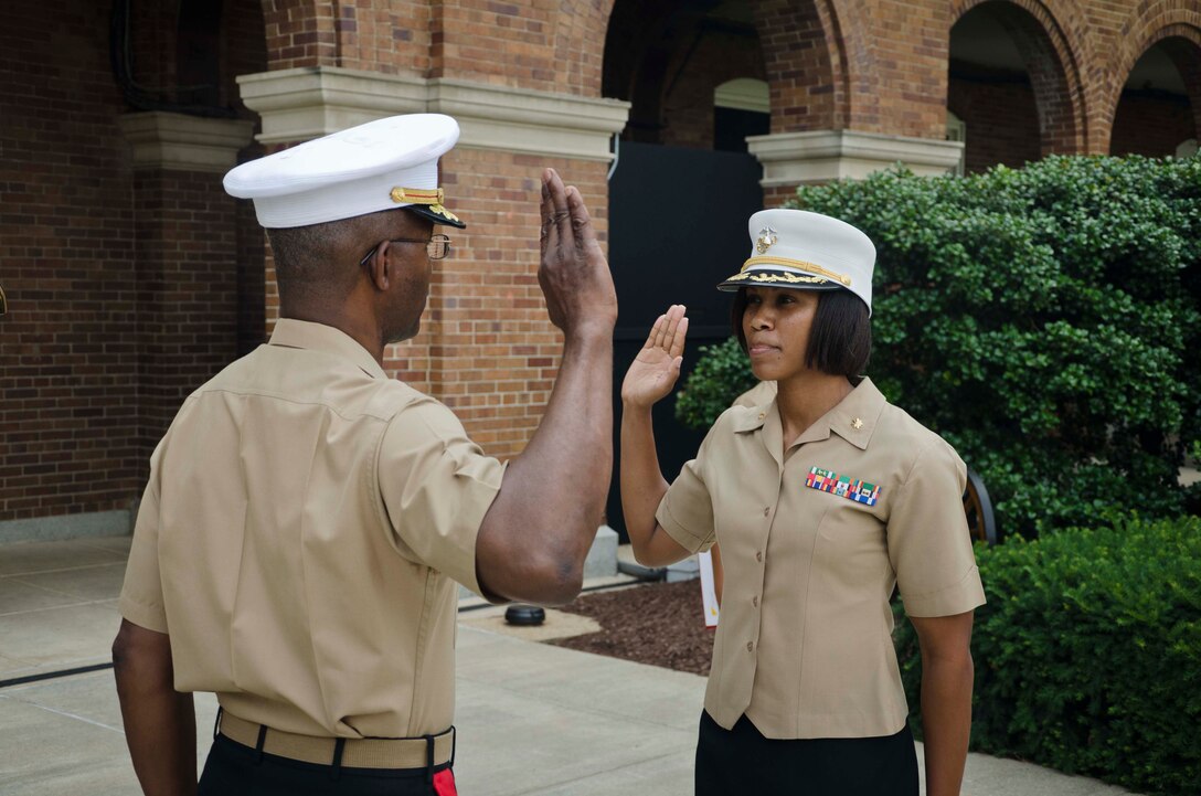 U.S. Marine Corps Maj. Lisa Lawrence recites the Uniformed Services Oath of Office during her promotion ceremony at Marine Barracks Washington, D.C., June 6, 2015. Lawrence, a native of Houston, has served in the Marine Corps for 11 years as a public affairs officer, completing combat tours in both Iraq and Afghanistan. She currently serves as an officer selection officer for Recruiting Station Baltimore, where she is tasked with recruiting highly qualified men and women who desire to become Marine officers. (U.S. Marine Corps photo by Sgt. Bryan Nygaard/Released)