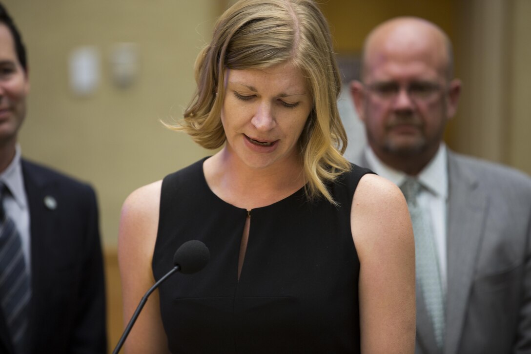 Kristin Camper, community plans and liaisons director for Marine Corps Air Station Miramar, talks about her experience working with Col. John P. Farnam, commanding officer of MCAS Miramar, during the proclamation for “Colonel John P. Farnam Day” at the San Diego City Council, July 28. Council members present during the proclamation also spoke about the initiatives Farnam took while at MCAS Miramar, including water and energy conservation aboard the installation. (U.S. Marine Corps photo by Cpl. Michael Thorn/Released)