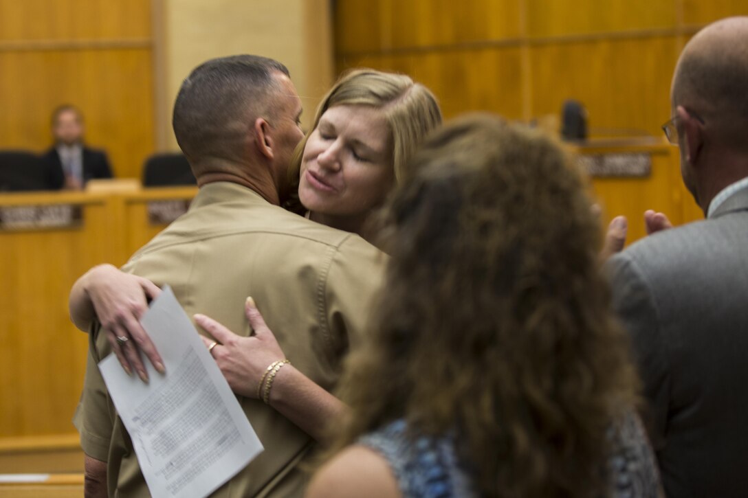 Kristin Camper, community plans and liaisons director for Marine Corps Air Station Miramar, hugs Col. John P. Farnam, commanding officer of MCAS Miramar, after the proclamation for “Colonel John P. Farnam Day” at the San Diego City Council, July 28. Council members present during the proclamation also spoke about the initiatives Farnam took while at MCAS Miramar, including water and energy conservation aboard the installation. (U.S. Marine Corps photo by Cpl. Michael Thorn/Released)