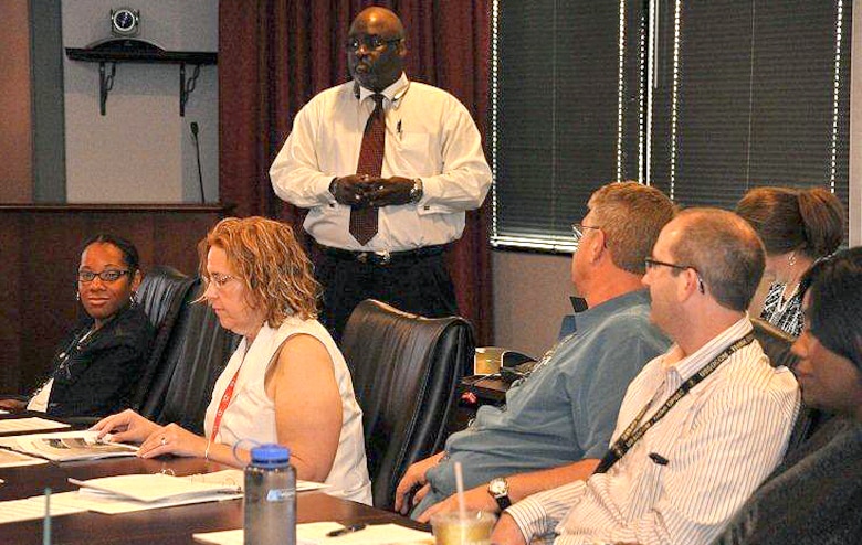 Arthur Martin III, of the Engineering and Support Center, Huntsville, provides instruction during Contracting Boot Camp July 28 as mentee Tiffany Torres, far left, looks on.